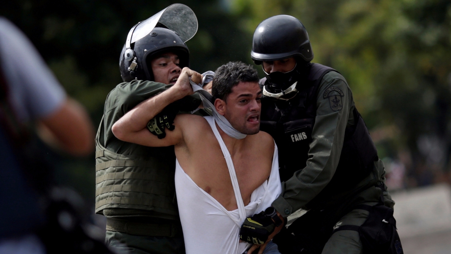 Venezuelan police remove protester